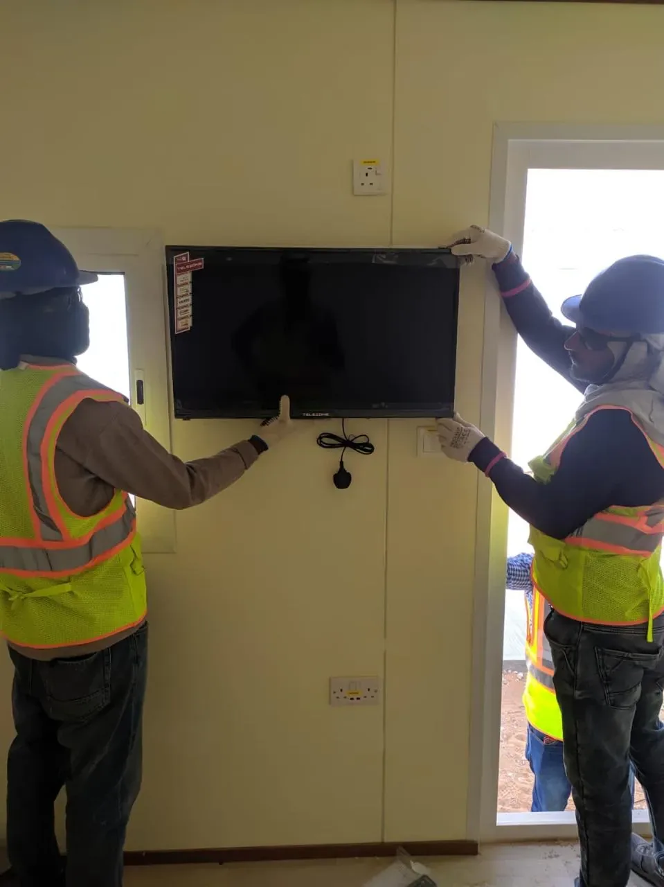 Jeddah hospitality delivery image of smart TV installation inside labour camp accommodation rooms for the Aramco JGC project